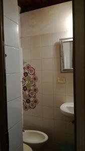 a bathroom with a toilet and a sink at I Vespri in Catania