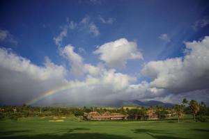 a rainbow in the sky over a golf course at Kaanapali Maui at the Eldorado by OUTRIGGER in Lahaina