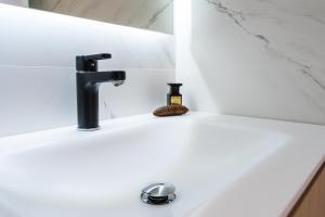 a bathroom sink with a black faucet at Airoto by Totiaran in Baqueira-Beret