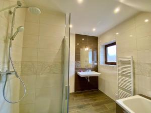 a bathroom with a shower and a sink at Villa Jarka Rent in Ždiar