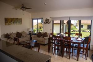 a kitchen and living room with a table and chairs at Hacienda Los Molinos Boutique Hotel & Villas in Boquete