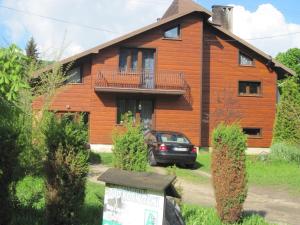 a house with a car parked in front of it at podkornutami in Sękowa