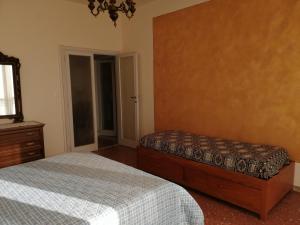 a bedroom with two beds and a dresser and a window at Appartamento Beatrice in Pistoia