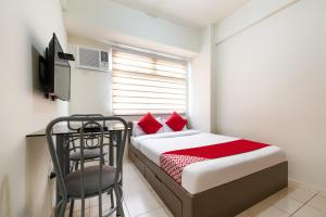 a small bedroom with a bed and a chair at OYO 474 Urbandeca Tower 316 - Nizami Condotel in Manila
