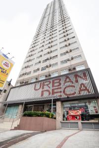 a tall building with a sign on the side of it at OYO 474 Urbandeca Tower 316 - Nizami Condotel in Manila