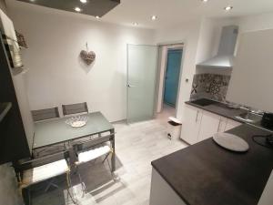 a kitchen with a table and a counter top at Via Corso in Rijeka +48 photos