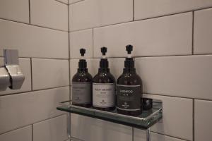 three bottles of wine sitting on a shelf in a bathroom at Gray Hotel Busan Station in Busan +64 photos