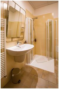 a bathroom with a sink and a shower and a mirror at Santa Teresa House in Verona