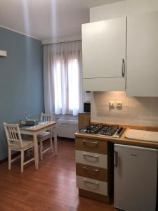 a kitchen with a table and a stove top oven at Al teatro in Padova