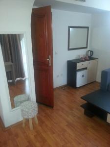 a living room with a door and a chair and a mirror at The Bulevard Hotel in Skopje