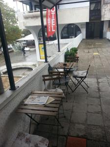 a group of tables and chairs outside of a building at The Bulevard Hotel in Skopje