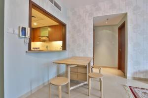 a dining room with a table and two stools at OYO 398 Home Standpoint Tower A , 1 BR in Dubai