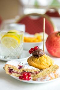 a plate of food with a pastry and fruit on it at Hotel De Londres in Rimini