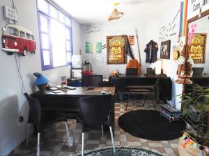 a room with a table and chairs and a desk at Soul Hostel Natal in Natal