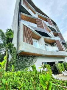 a building with a vertical garden on the side of it at Lemonade Phuket Hotel -SHA Plus in Chalong