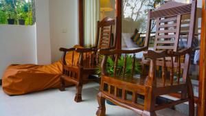 a living room with two chairs and a mirror at Shining Green View in Ella +167 photos