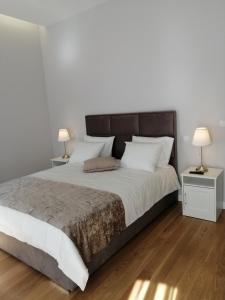 1 dormitorio con 1 cama grande y 2 lámparas en Casa Victória en Ponte da Barca