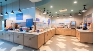a large kitchen with cabinets and counters in a store at Holiday Inn Express & Suites Warner Robins North West, an IHG Hotel in Warner Robins