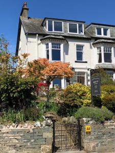 a large white house with a sign in front of it at Skiddaw Croft Bed & Breakfast in Keswick