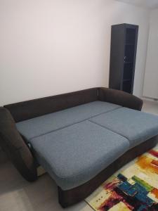 a bed in a living room with a couch at CASA Unchiu' ( uncle's house ) in Braşov