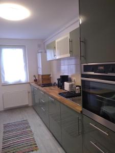 a kitchen with stainless steel appliances and a window at CASA Unchiu' ( uncle's house ) in Braşov