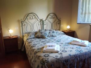 a bedroom with a bed with two towels on it at Badia il Vingone in Città di Castello