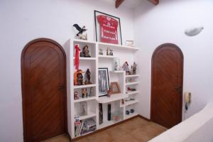 a room with two wooden doors and white shelves at Family House in Lima
