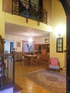 a living room with a table and chairs at Rosalia Suites in Loma Hermosa