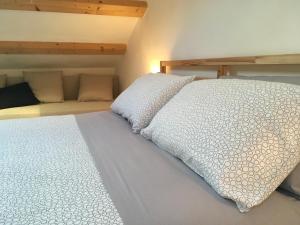 a bedroom with a white bed with a pillow on it at La casa di Julie in Ronchi dei Legionari