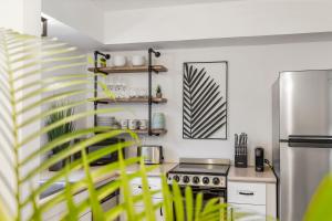 a kitchen with a stove and a refrigerator at Alani Bay Premium Condos in Fort Lauderdale