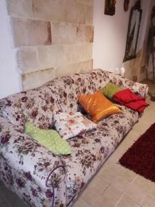 a couch with pillows on it in a living room at monolocale "le sciabiche" in Brindisi