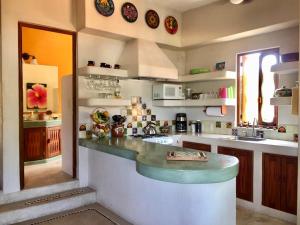 a kitchen with a counter top in a room at Newer & Roomy w/2 Pools. No Car Needed. Beaches, Restaurants & Shopping W/I walking distance. Taxis and buses abundant for reasonable price if needed in Zihuatanejo