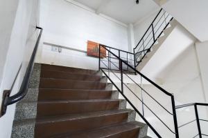 a staircase in a house with metal railings at OYO 425 Residences By Sirc in San Fernando