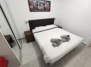 a bedroom with a bed with two towels on it at Vacation Apartment Eilat in Eilat +53 photos