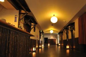 a hallway of a building with lights on the ceiling at Yadoya Tsubaki in Aomori