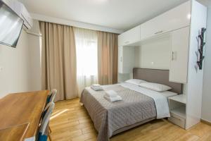 
a hotel room with a bed and a desk at Athens Raise Acropolis Project in Athens

