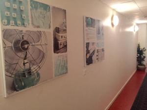 a hallway with four pictures on the wall at Linné Hostel in Gothenburg