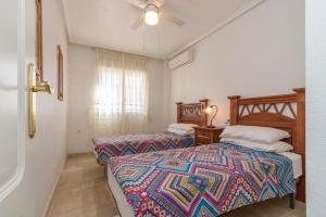 Cama o camas de una habitación en Townhouse Playa Flamenca