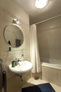 a bathroom with a sink and a mirror and a tub at Apartmán Tatran Donovaly Deluxe in Donovaly +17 photos