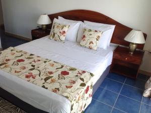 貝聖安那的住宿－洞穴公寓式酒店，一间卧室配有一张床和两个带灯的床头柜