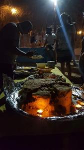 a group of people preparing food on a table at sea horse in Nuweiba
