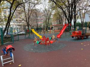 a park with a playground with slides and a swing set at City center - Unirii studio in Bucharest