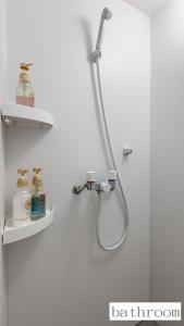 La salle de bains est pourvue d'une douche et de 2 étagères murales. dans l'établissement 玉出サクラハウスシングルルーム wifi付 玉出駅から徒歩2分 地下鉄難波迄8分, à Osaka 12 autres photos