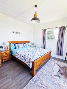 a bedroom with a bed and a desk and a window at 180 degrees sea view 180度全海景房 in Oamaru