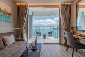 a living room with a couch and a table at Handy Panorama Nha Trang Ocean view by HDG in Nha Trang