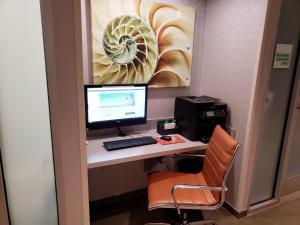 an office with a desk with a computer and a printer at Holiday Inn New York City - Times Square, an IHG Hotel in New York