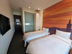 Rúm í herbergi á Merryday Hotel Banqiao