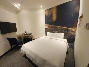 Rúm í herbergi á Merryday Hotel Banqiao