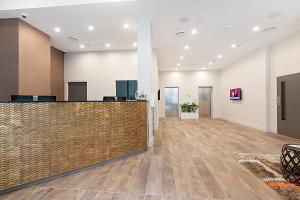 a lobby of a hospital with a reception desk at Ramada Suites Victoria Street West in Auckland