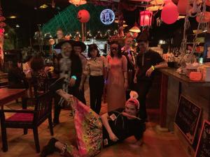 a group of people standing in a bar at Joe's Cafe & Garden Resort in Mui Ne